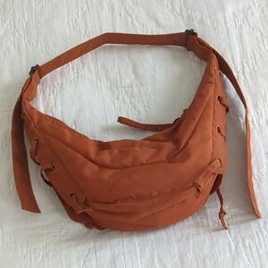 Orange Crescent Crossbody Bag with Soft Fabric and Versatile Straps